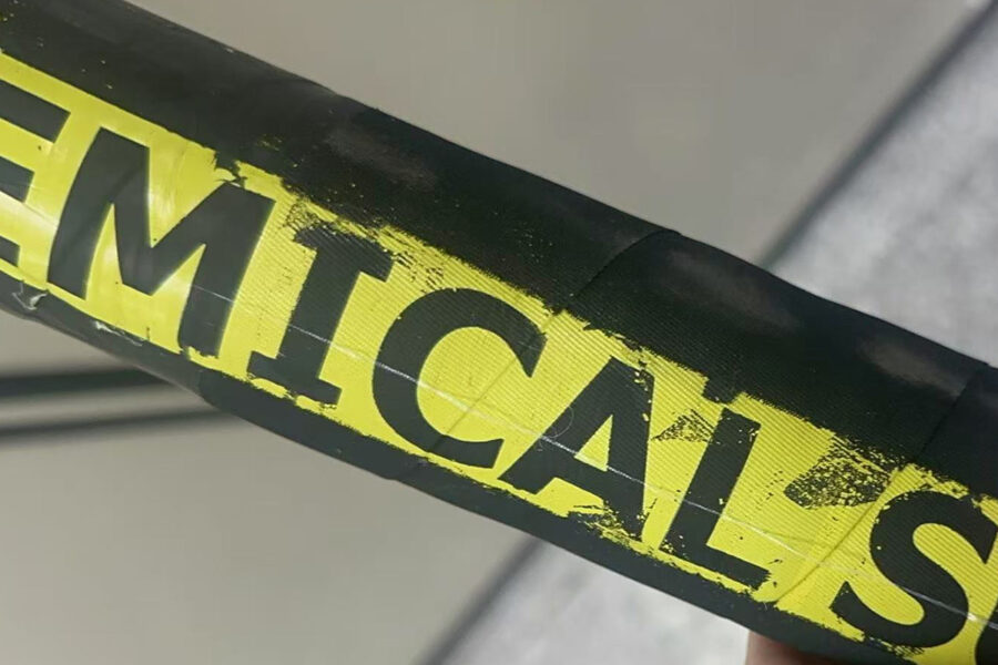 Close-up of a defective rubber transfer label peeling off due to low pressure